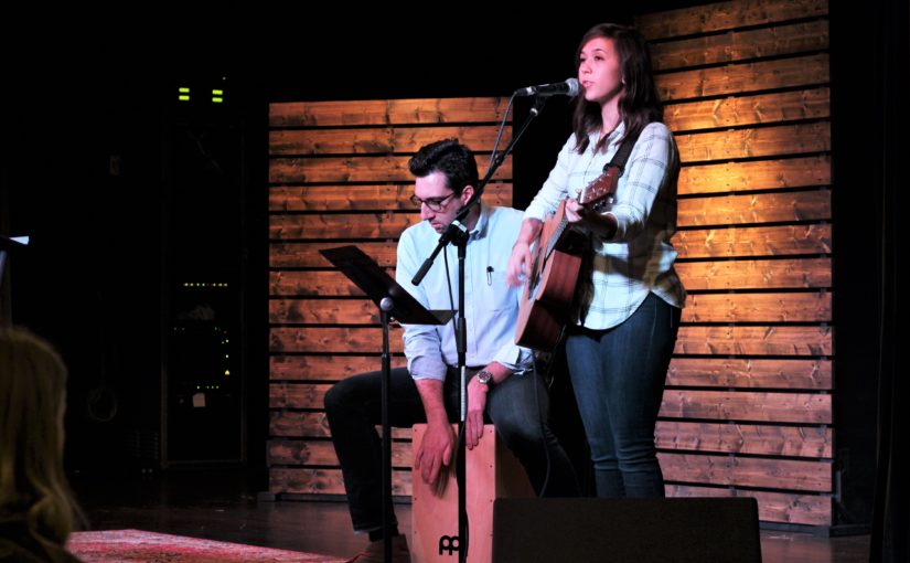 A student and professor duo providing praise music during chapel.