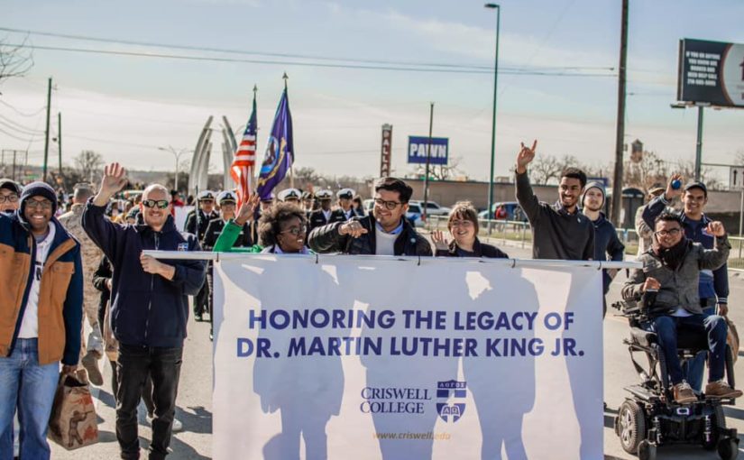 Students, faculty, and staff honoring the legacy of Dr. Martin Luther King Jr. as they participate in Dallas' MLK parade.