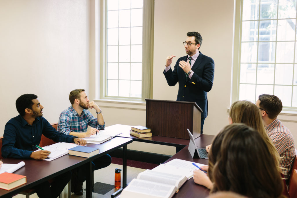 Professor engaging students in a classroom setting