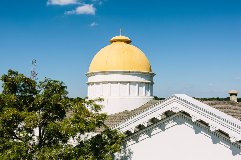 Golden Criswell dome against a bright blue sky