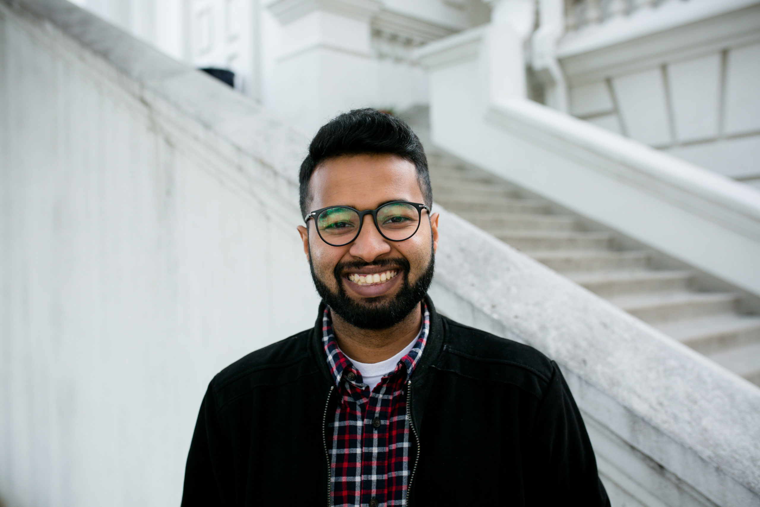 Smiling student portrait closeup in front of the library steps.